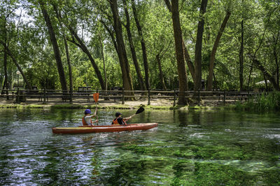 People sitting on boat in lake