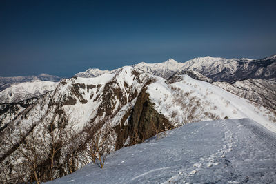 Snowcapped mountains against clear sky