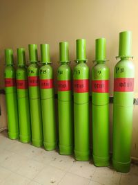 Close-up of various bottles on shelf against wall