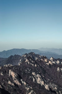 Scenic view of rocky mountains against clear blue sky