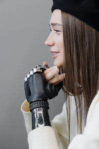 A european woman with a bionic prosthesis on her arm is talking to friends in a public place