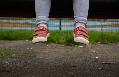 Low section of girl over footpath