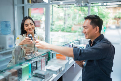 Side view of woman using mobile phone