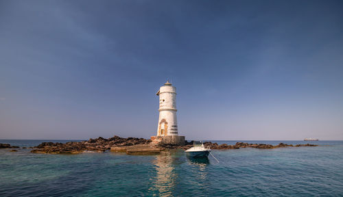 The mangiabarche lighthouse of the boat eater of calasetta, south sardinia,on a beautiful summer day