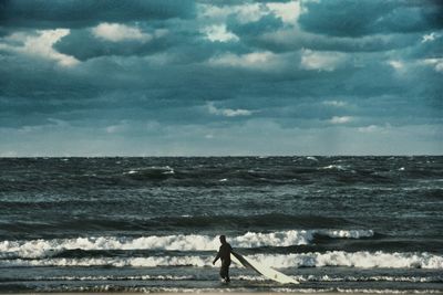 Scenic view of sea against cloudy sky