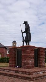 Low angle view of man against built structure against sky