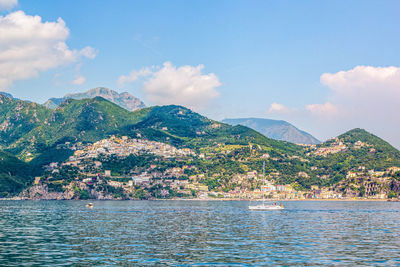 Panoramic view of small haven of amalfi village with turquoise sea and colorful houses on slopes 