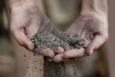 Close-up of human hand holding stone