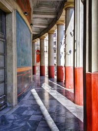 Empty corridor along pillars
