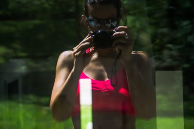 Man photographing with pink camera