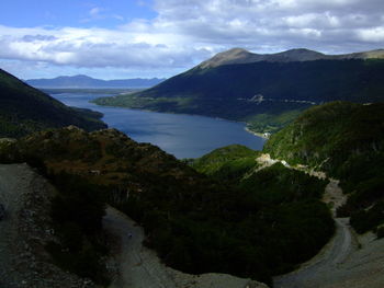 Scenic view of sea and mountains against sky