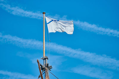 Low angle view of crane against blue sky