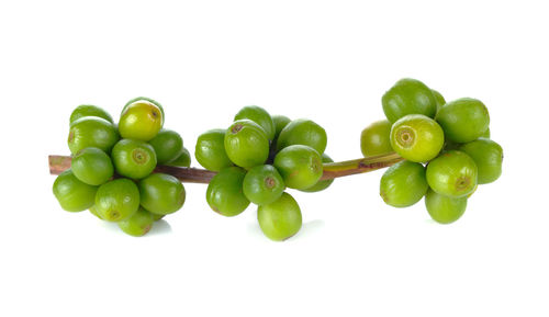 Close-up of grapes over white background