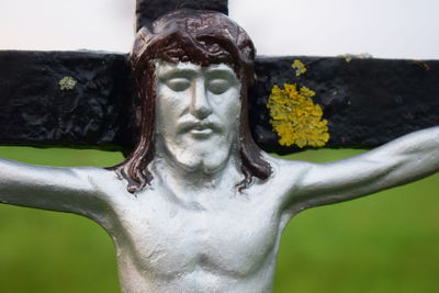 Close-up of angel statue with flower head