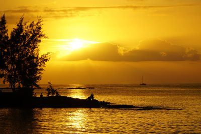 Scenic view of sea against orange sky