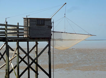 Tradicional carrelet on beach against sky