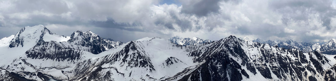 Scenic view of snowcapped kyrgyz mountains against sky