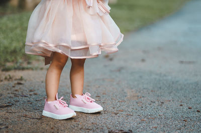 Low section of woman standing on ground