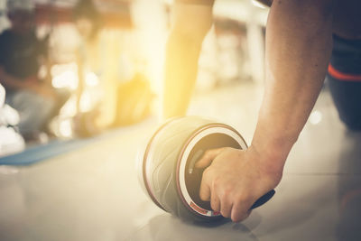Cropped image of man exercising at gym