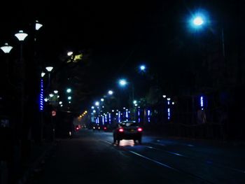Cars on road in city at night