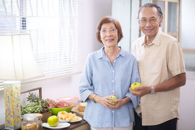 Portrait of a smiling young man holding food