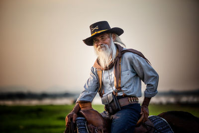 Senior man sitting on horse