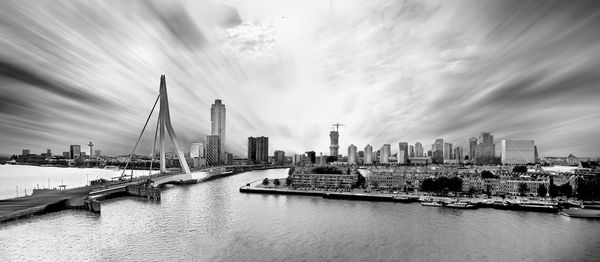 Panoramaview of the skyline of rotterdam with erasmus bridge in black and white