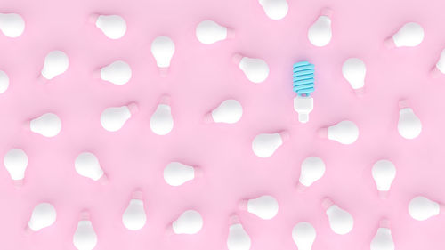 Full frame shot of light bulbs against pink background