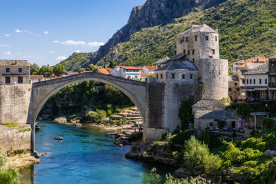 Bridge over river against mountain