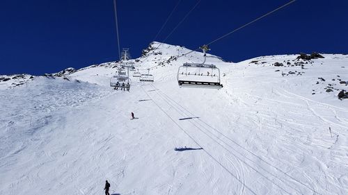 View of ski lift on snowcapped mountain