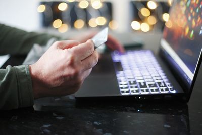 Midsection of man using mobile phone