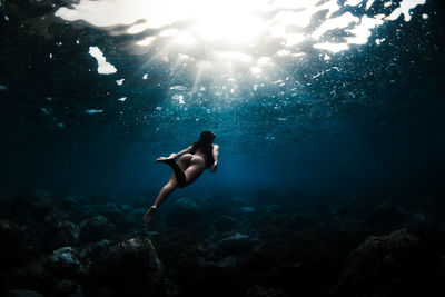 Young girl snorkeling on the beach with swimwear 