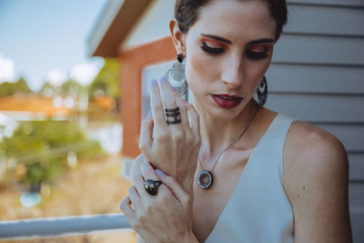 Portrait of young woman looking away outdoors