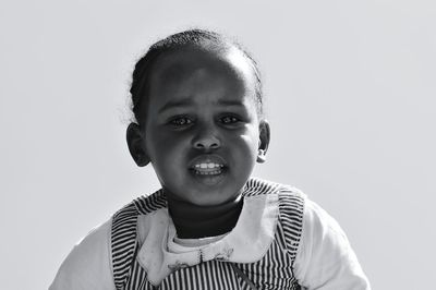 Portrait of cute boy against white background