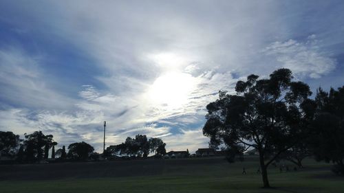 Scenic view of grassy field against cloudy sky
