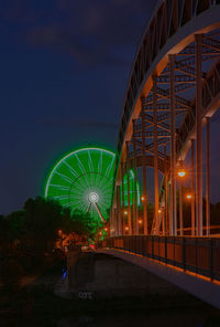 Illuminated ferris wheel at night