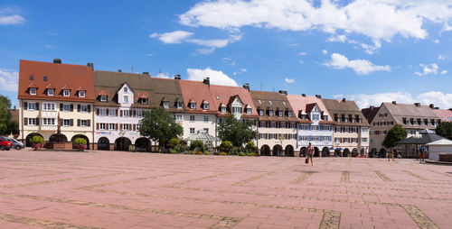 Panoramic view of people in city against sky