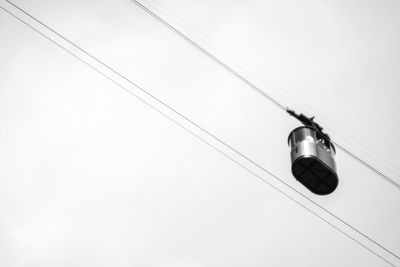 Low angle view of electric lamp hanging against ceiling