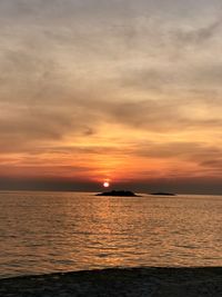 Scenic view of sea against romantic sky at sunset