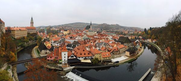 Aerial view of river and town against sky 