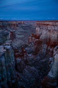 Scenic view of rock formations against blue sky at dusk