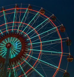 Low angle view of illuminated ferris wheel at night