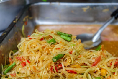 Close-up of som tam salad in container