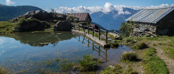 Waterfront with built structures against sky