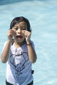 Portrait of cute girl standing in swimming pool