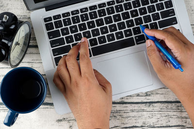 High angle view of person using laptop on table