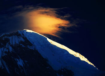 Snowcapped mountain peak at dawn