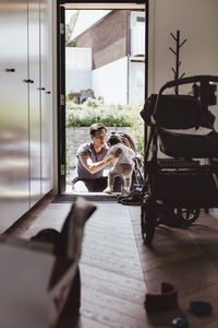 Father helping son learning to walking at doorway