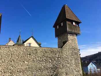 Low angle view of old building against blue sky