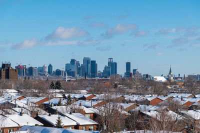 Aerial view of townscape against sky during winter